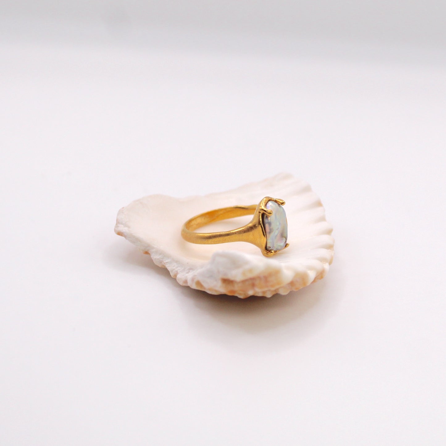 Handmade organic design ring with freshwater pearl, crafted in Lisbon. Minimalist, sculptural jewelry inspired by ocean waves