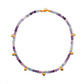 Multicolored beaded Fluorite necklace with gold charm on a white background